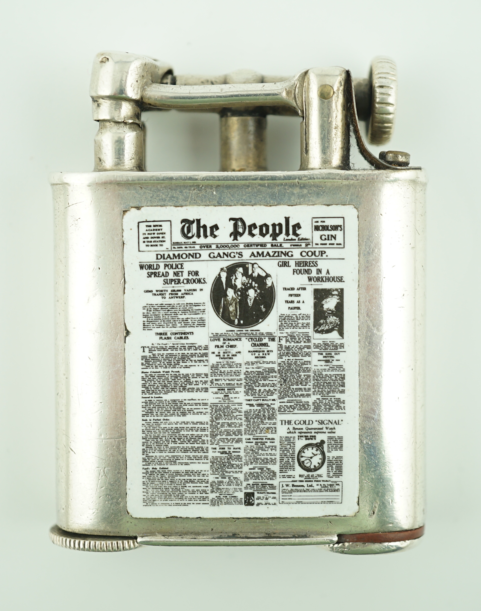 A George V silver novelty lighter, with two colour enamelled panel of 'The People' newspaper front cover dated May 5th, 1929